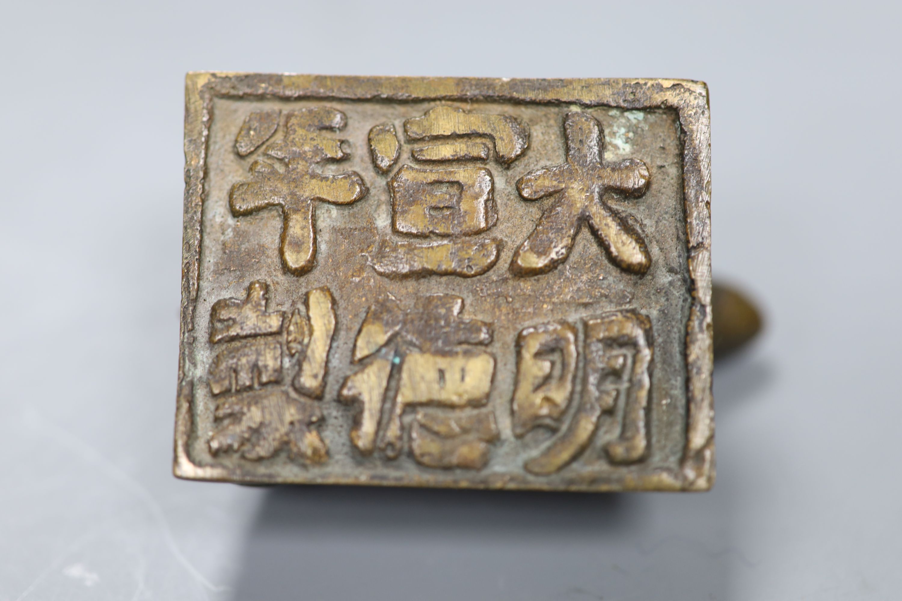 A group of Chinese bronze seals and a white metal elephant